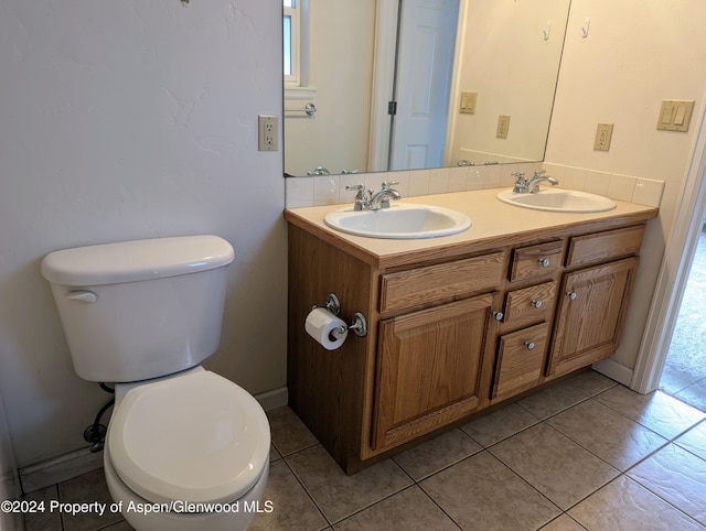 bathroom featuring toilet, vanity, and tile patterned floors