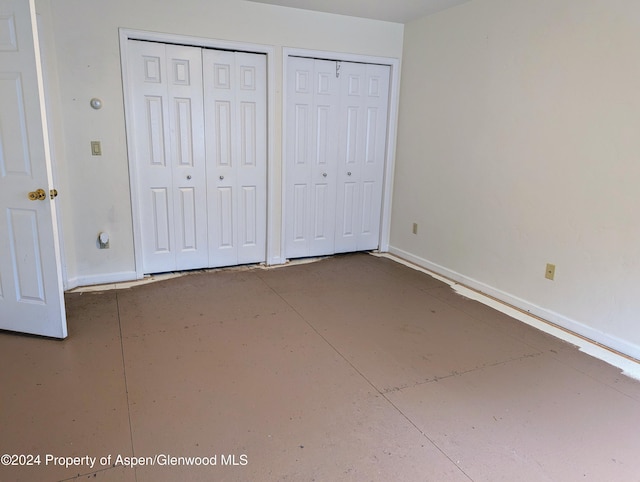 unfurnished bedroom featuring multiple closets