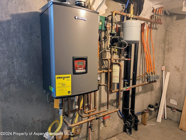 utility room featuring tankless water heater