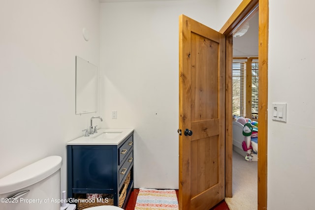 bathroom featuring toilet and vanity