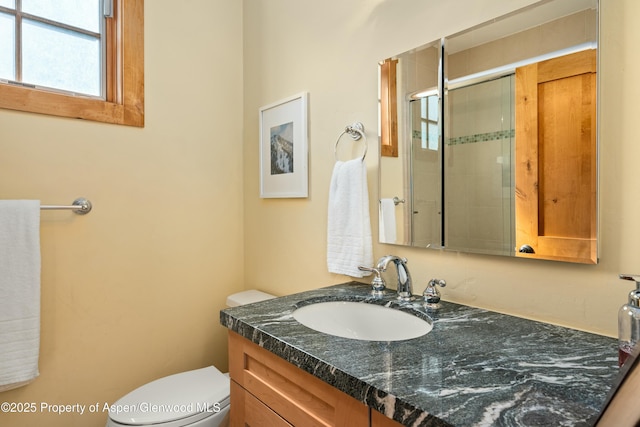 full bathroom with toilet, a shower stall, and vanity