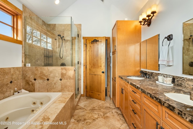 bathroom with a stall shower, a sink, lofted ceiling, and a whirlpool tub