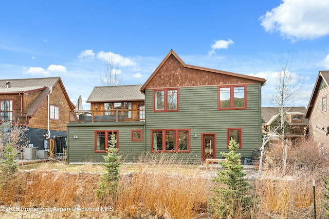 back of house with a balcony and central AC