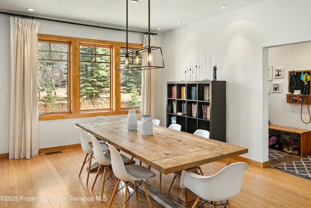 dining space with hardwood / wood-style flooring, recessed lighting, visible vents, and baseboards