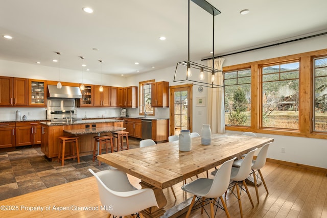 dining room with recessed lighting, dark wood finished floors, and baseboards