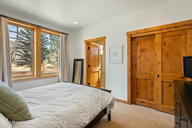 bedroom with recessed lighting, light colored carpet, and baseboards