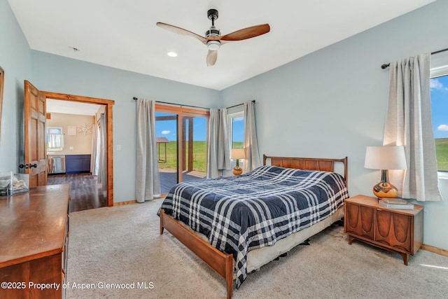 carpeted bedroom featuring access to exterior, multiple windows, ceiling fan, and baseboards