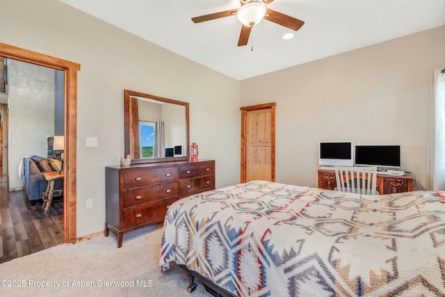 carpeted bedroom with a ceiling fan and baseboards