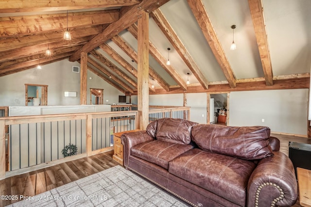 living area with lofted ceiling with beams, light wood-style flooring, and visible vents