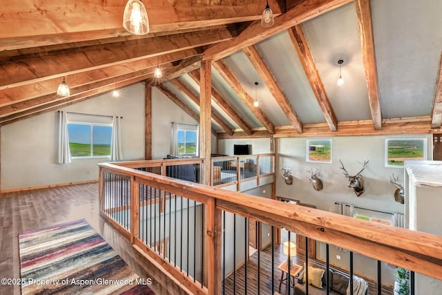 bonus room featuring lofted ceiling with beams and baseboards