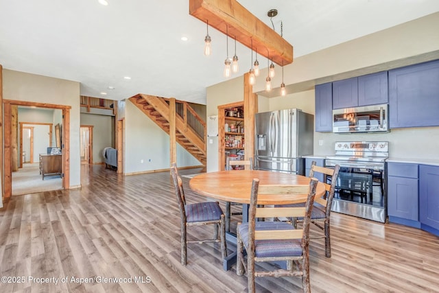 dining area featuring light wood finished floors, baseboards, beamed ceiling, stairs, and recessed lighting