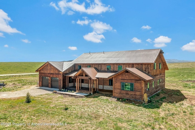 view of front of home featuring a garage, a porch, a rural view, gravel driveway, and a front lawn