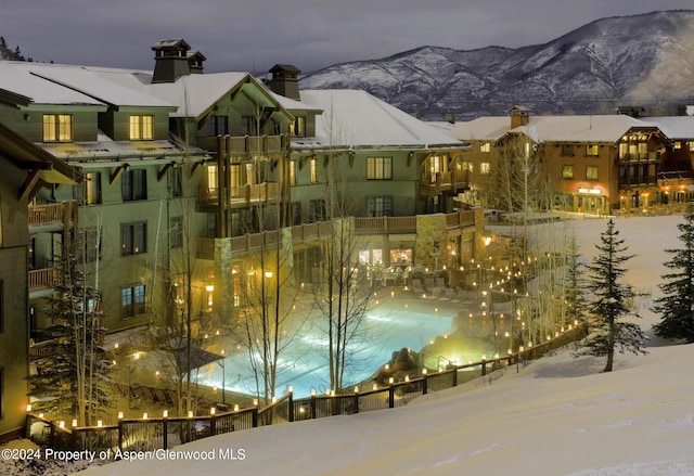 snow covered pool featuring a mountain view