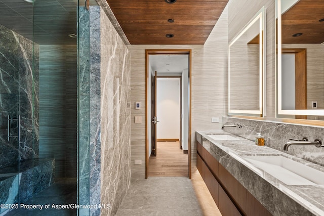 bathroom featuring wooden ceiling, double vanity, and a sink