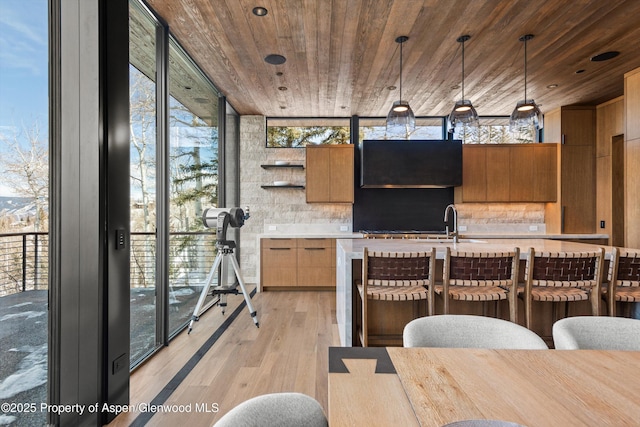 kitchen featuring wooden ceiling, light countertops, open shelves, and expansive windows