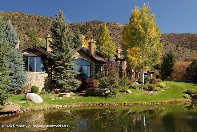 120 Running Mare Rd, Woody Creek, CO 81656 - back of house featuring a yard, stone siding, and a water view