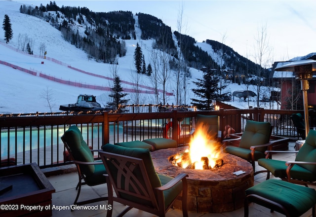 197 Prospector Rd Unit 2302-11, Aspen, CO 81611 - snow covered deck featuring a fire pit and a mountain view