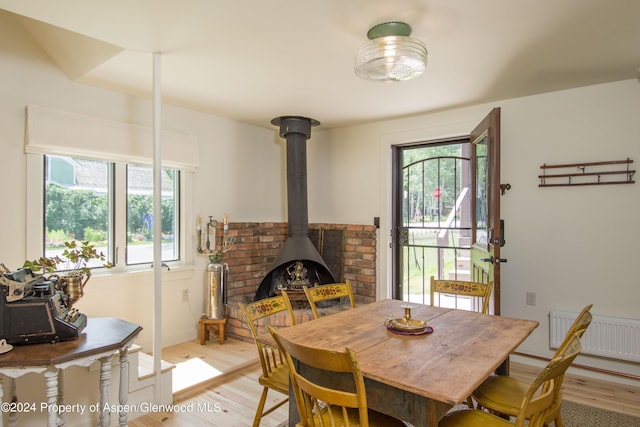 500 W Francis St, Aspen, CO 81611 - dining space featuring plenty of natural light, light wood-style flooring, visible vents, and a wood stove