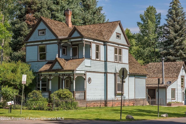 500 W Francis St, Aspen, CO 81611 - view of front facade featuring a front lawn, a porch, a chimney, and fence