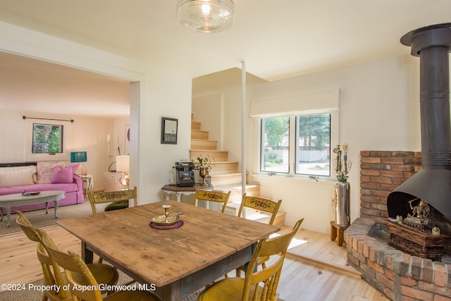 500 W Francis St, Aspen, CO 81611 - dining area with light wood-style flooring, a wealth of natural light, stairs, and a wood stove