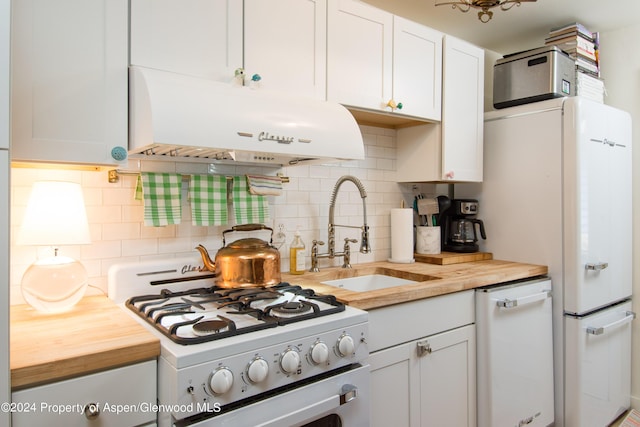 500 W Francis St, Aspen, CO 81611 - kitchen with decorative backsplash, range hood, white appliances, and wooden counters