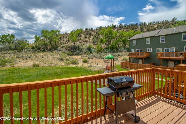 2433 Pine Ln, Rifle, CO 81650 - deck featuring a playground and a grill