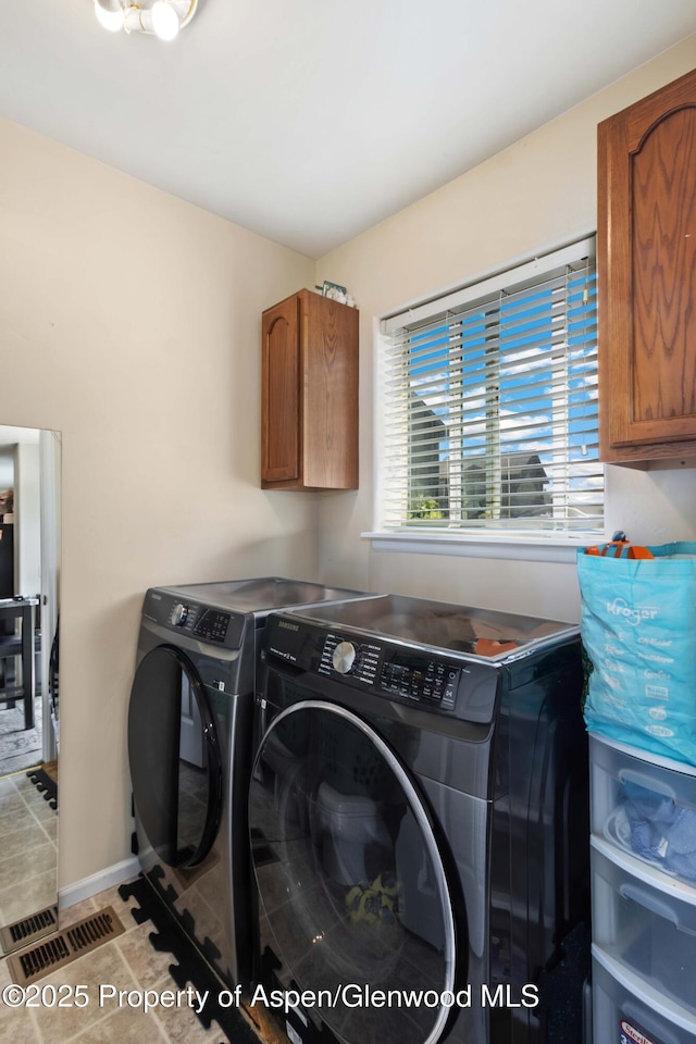 2433 Pine Ln, Rifle, CO 81650 - laundry area with separate washer and dryer and cabinet space