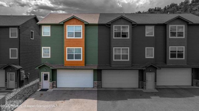 2433 Pine Ln, Rifle, CO 81650 - view of property with an attached garage and stone siding