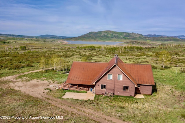 drone / aerial view with a water and mountain view