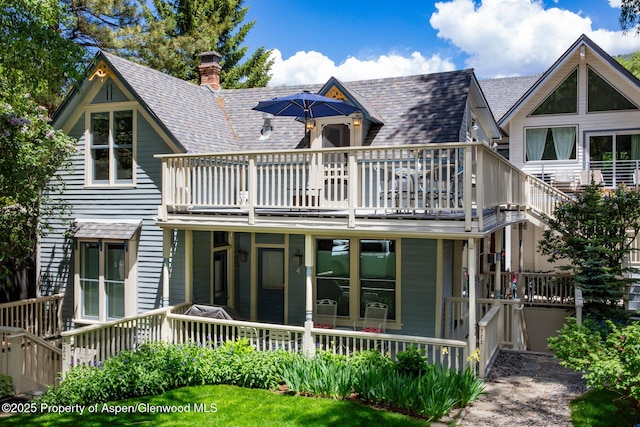 222 W Hopkins Ave Unit 5, Aspen, CO 81611 - back of property featuring roof with shingles, a chimney, and a deck