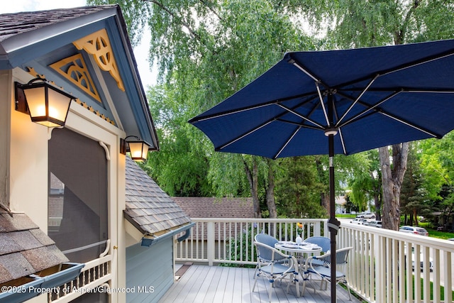 222 W Hopkins Ave Unit 5, Aspen, CO 81611 - wooden terrace with outdoor dining space and view of wooded area
