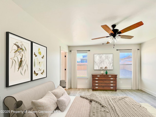 1652 E 17th Cir, Rifle, CO 81650 - bedroom featuring multiple windows, light wood-style flooring, and ceiling fan
