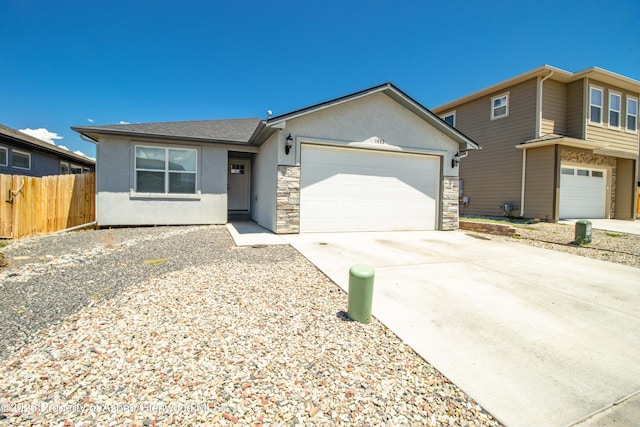 1652 E 17th Cir, Rifle, CO 81650 - view of front of house with stucco siding, driveway, an attached garage, and stone siding
