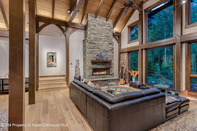 900 Dorais Way, Redstone, CO 81623 - living room with hardwood / wood-style floors, wooden ceiling with exposed beams, high vaulted ceiling, a fireplace, and ceiling fan