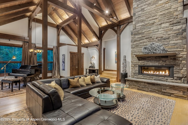 900 Dorais Way, Redstone, CO 81623 - living room with light wood finished floors, wood ceiling with exposed beams, a fireplace, high vaulted ceiling, and a chandelier