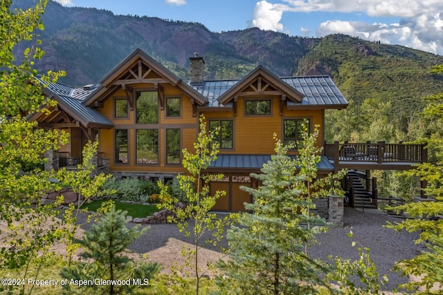 900 Dorais Way, Redstone, CO 81623 - view of front of house with a standing seam roof, metal roof, stairs, and a chimney