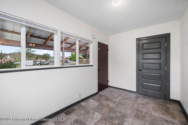 580 Curtis Ave, De Beque, CO 81630 - unfurnished room featuring baseboards and stone finish flooring