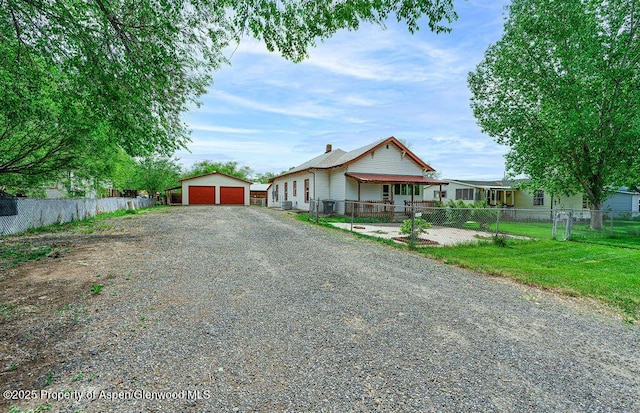 580 Curtis Ave, De Beque, CO 81630 - view of front of property with an outdoor structure, a detached garage, and a chimney