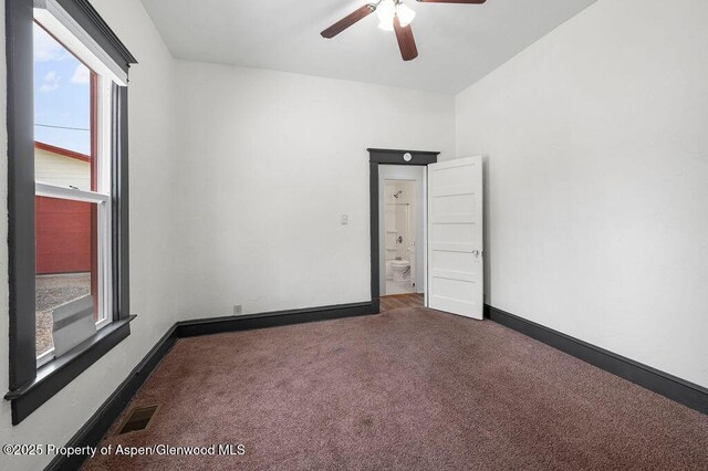 580 Curtis Ave, De Beque, CO 81630 - empty room with healthy amount of natural light, carpet, ceiling fan, and baseboards