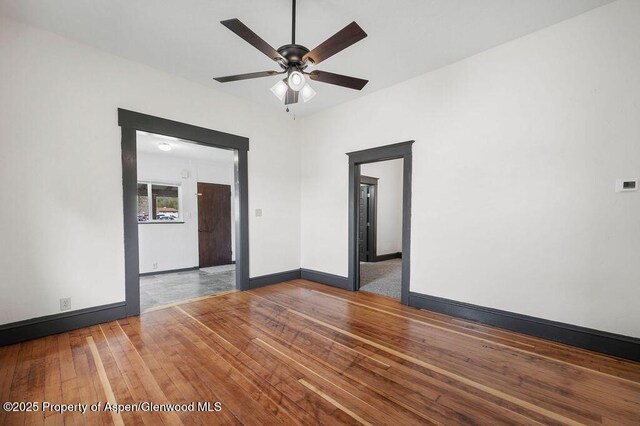 580 Curtis Ave, De Beque, CO 81630 - empty room featuring a ceiling fan, hardwood / wood-style floors, and baseboards