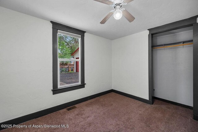 580 Curtis Ave, De Beque, CO 81630 - unfurnished bedroom with carpet, a closet, baseboards, and a ceiling fan