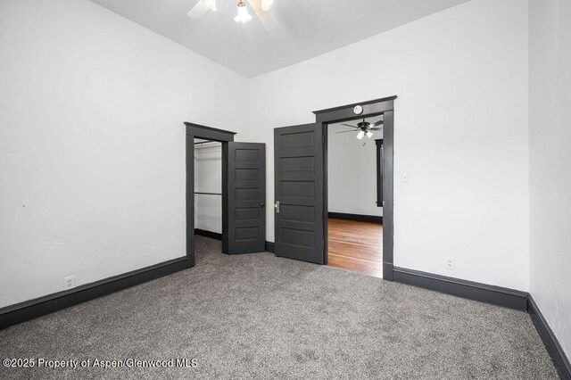 580 Curtis Ave, De Beque, CO 81630 - unfurnished bedroom featuring carpet flooring, baseboards, ceiling fan, and a high ceiling