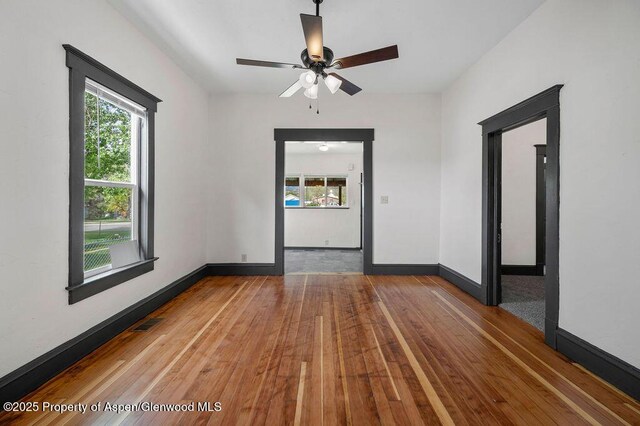 580 Curtis Ave, De Beque, CO 81630 - spare room with wood-type flooring, healthy amount of natural light, baseboards, and a ceiling fan
