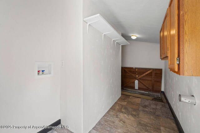 580 Curtis Ave, De Beque, CO 81630 - clothes washing area with washer hookup, stone finish floors, cabinet space, and baseboards