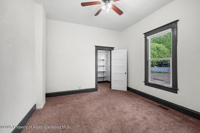 580 Curtis Ave, De Beque, CO 81630 - unfurnished bedroom featuring carpet flooring, baseboards, and ceiling fan