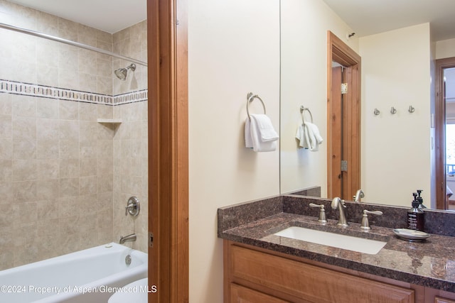 bathroom with vanity and tiled shower / bath combo