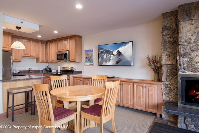 dining room featuring a stone fireplace