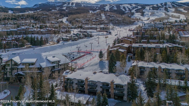 snowy aerial view with a mountain view