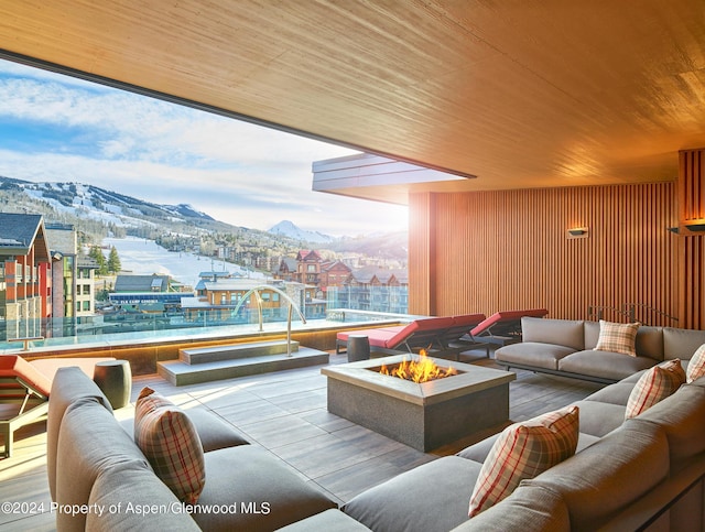 interior space featuring a mountain view, wooden ceiling, and wood walls