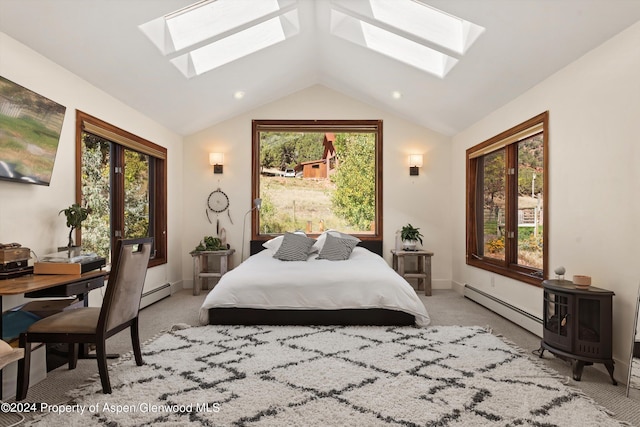 carpeted bedroom featuring baseboard heating and lofted ceiling with skylight